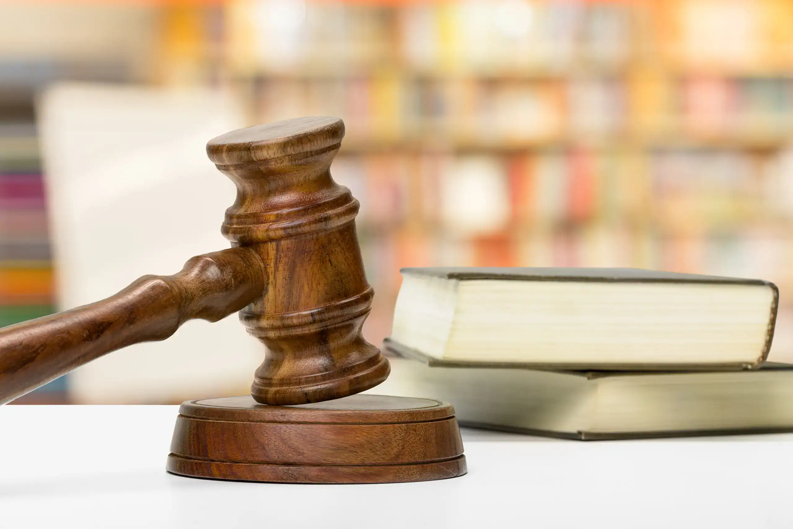Wooden gavel and books on wooden table