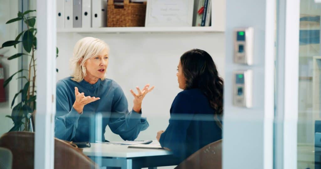 Female HR Manager counseling female employee in an office how to deal with difficult employees
